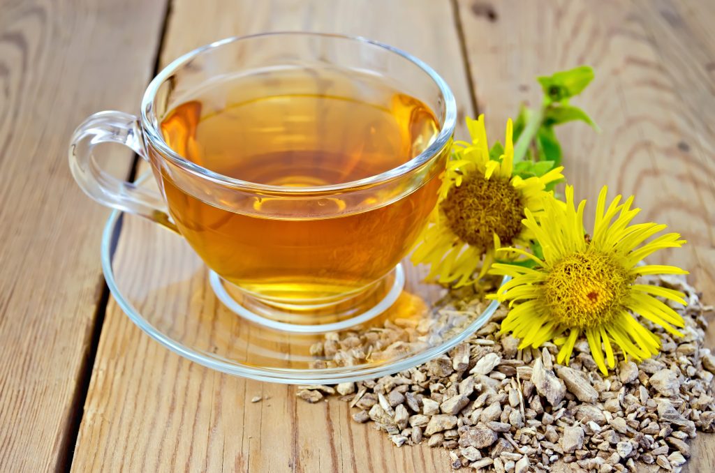 Herbal tea from root of elecampane with flower on board