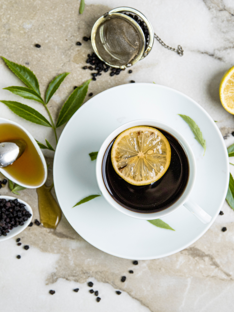 cup of elderberry tea with lemon